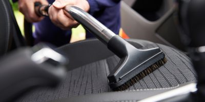 Man Hoovering Seat Of Car During Car Cleaning; Shutterstock ID 290850902; PO: today.com mish